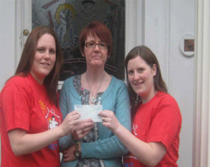 Shura and Claire present cheque to Beryl